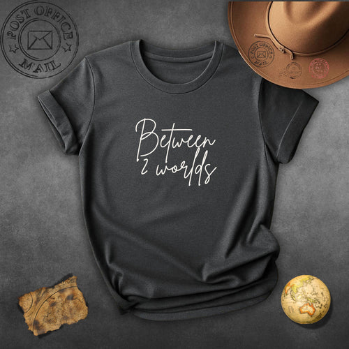 Between 2 Worlds T‑Shirt — Minimal Script Tee for Dreamers & Travelers
